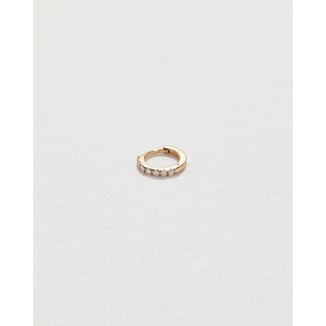tiny pavé huggie in yellow gold