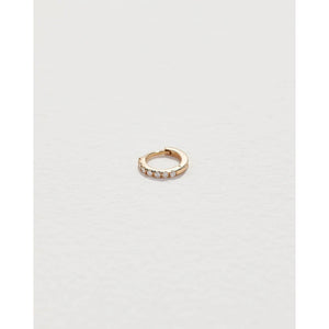 tiny pavé huggie in yellow gold