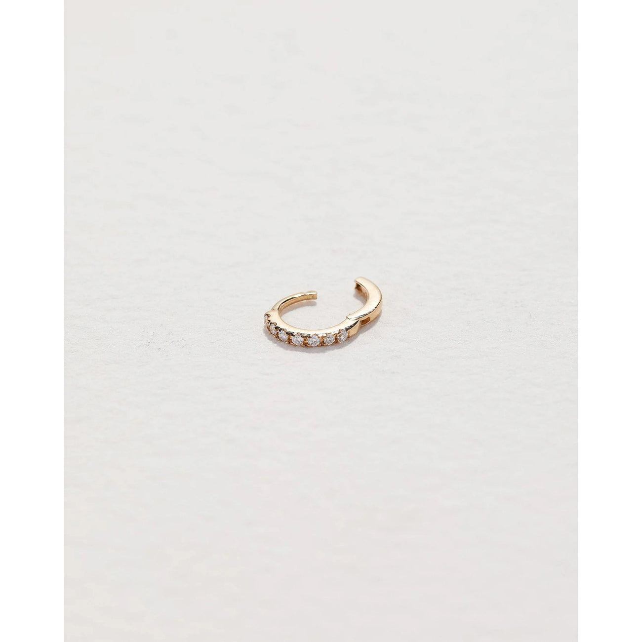 tiny pavé huggie in yellow gold