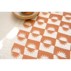 sunrise linen tea towel in sienna